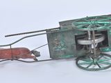 a toy horse pulling a carriage with a man in it