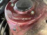 a close up of a red gas canister on the ground