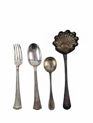 four spoons, a fork, and a spoon on a white background