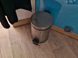 a trash can sitting on the floor next to a trash can