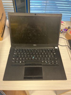a laptop that is sitting on a desk in front of a window