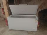 a white chest freezer sitting in the middle of a room