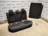 the back seats of a car are shown in front of a wall