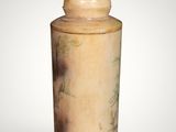 a small vase with a lid on a white surface