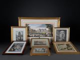 many framed pictures of different styles and sizes on the table