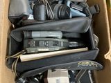 a cardboard box full of electronics and other items in it