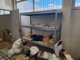 a room that has a bunch of boxes on the shelves