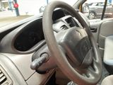 a steering wheel and dashboard of a car in a parking lot