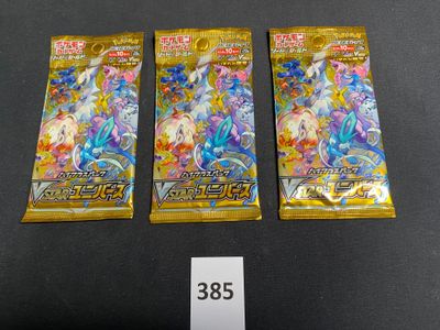 three packs of pokemon trading cards on a table