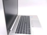a silver laptop with a black keyboard on a white surface