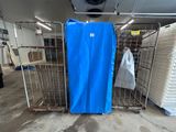 a blue tarp covering a metal cage in a warehouse