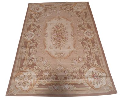 beige area rug with a floral design on a white background