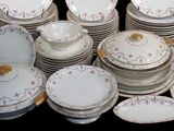a lot of plates and bowls that are stacked together