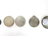 four different types of metal tags are shown on a white surface