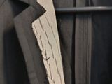 an image of a suit with a tie hanging on a hanger
