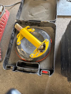 a tool box with a yellow handle and a tool in it