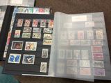 a lot of stamps in a folder on the floor
