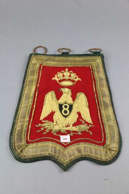 an image of a red and gold badge with a crown on it