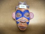 a mask on the wall with a name tag on it