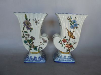 two vases that are sitting on a table