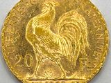 a close up of a gold coin with a rooster on it