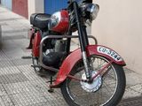a red motorcycle parked on the side of the street
