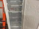 a white refrigerator with a door open in a room