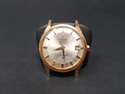 a watch that is sitting on a black surface