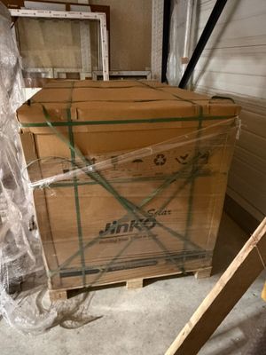 a cardboard box sitting on top of a pallet in a garage