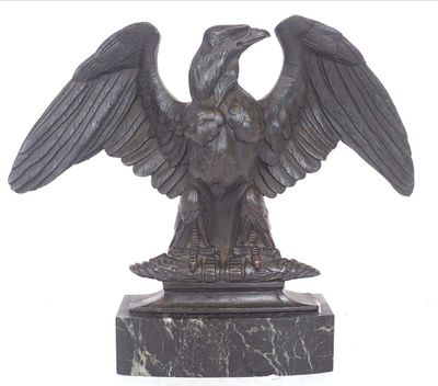 a statue of an eagle on a marble base