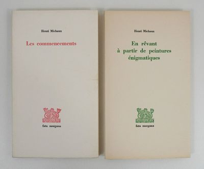 two books are sitting on a white surface one is open and the other is closed