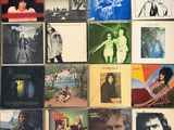 many different album covers on the table together