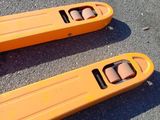 two orange skateboards sitting on the ground next to each other
