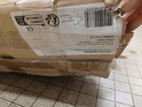 a person that is holding a box on the floor