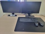 a computer desk with two monitors and a keyboard