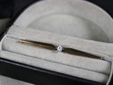 un stylo en or serti d'un diamant, présenté dans un étui