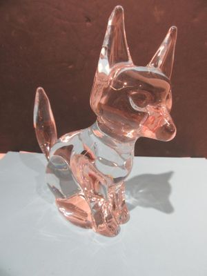 une figurine de chat en verre posée sur une table