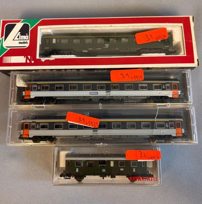 three boxed train cars with red labels on them sitting on a table