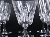 several empty wine glasses are lined up on a black surface