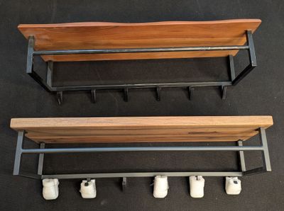 two wooden benches with wheels attached to them on a black surface