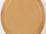 a brown plate on a white wall with a white background