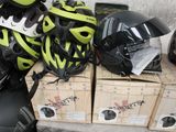 boxes of helmets and helmets are stacked on top of each other