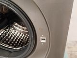 a close up of a washing machine with the door open