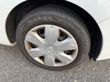 a white car with a flat tire on the street