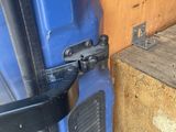 a close up of a door handle on a blue truck