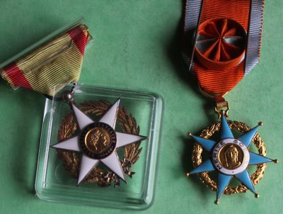 two medals and a medal on a green surface