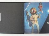 a book with a picture of a man holding a parrot