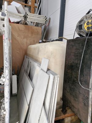 several pieces of wood are stacked on top of each other in a warehouse
