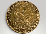 a close up of a gold coin with a rooster on it