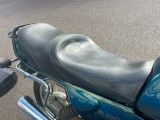 a blue motorcycle that is parked on the street